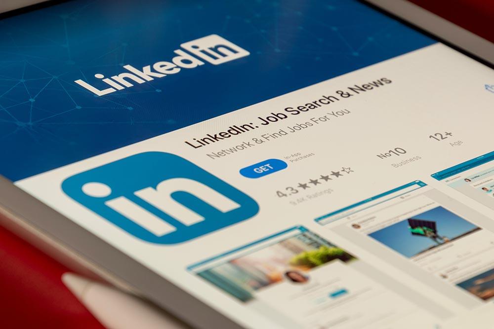Close-up of a tablet screen displaying the LinkedIn: Job Search & News app page in an app store, with the LinkedIn logo, app rating, and download button—an essential tool for HR recruitment professionals.
